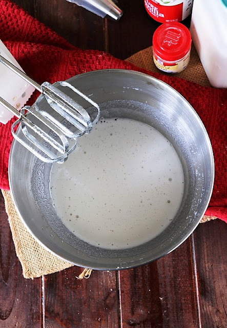 Combining 7-Minute Marshmallow Frosting Ingredients in Mixing Bowl Image