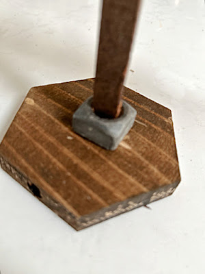 large nut on wooden base for weight