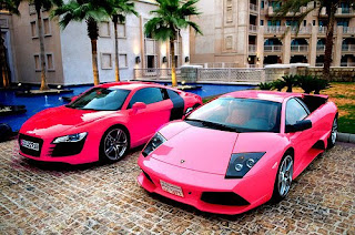 2 different pink coloured models of Audi car