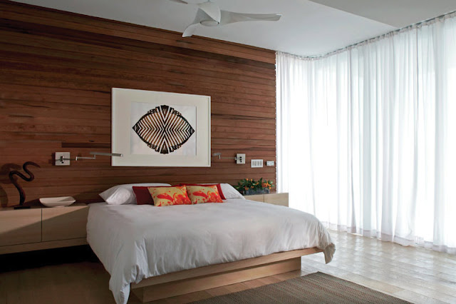 Modern bed by the wooden wall