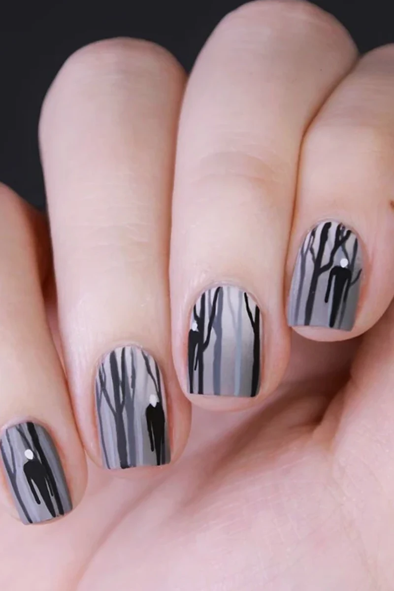 close-up of woman hand with a very cute and minimal halloween nail design with slender man