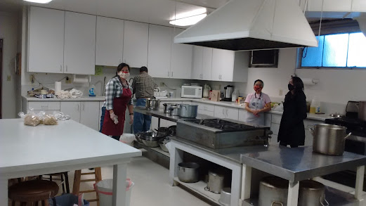 People preparing food in a large kitchen area