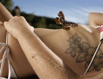 flower tattoo on a woman body side wearing a bikini
