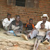 SITTING WITH HIS FIVE DISABLED CHILDREN