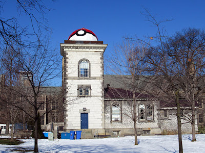 Small building with three storey tower topped by a dome, painted to resemble a Poke ball