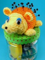 http://www.ravelry.com/patterns/library/hedgehog-pincushion-vessel