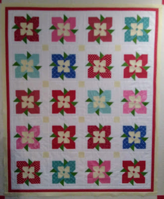 Patchwork quilt top composed of flower blocks