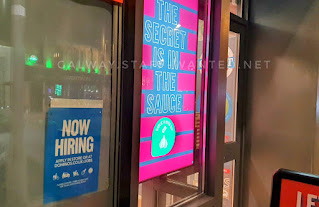 Job ad beside the secret is in the sauce - nlue writing on pink slabs
