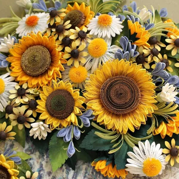 quilled sunflower arrangement with blue and white small flowers