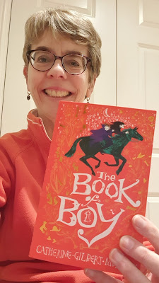 Ally Sherrick holding a copy of The Book of Boy by Catherine Gilbert Murdock