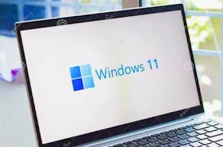 A laptop with Windows 11 logo on the screen