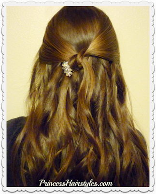 Simple half up hairstyle for Prom with rhinestone clip.