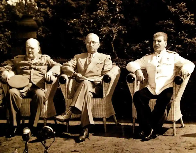 Potsdam Conference: Prime Minister Winston S. Churchill, President Harry S. Truman, and Premier Joseph Stalin pose for a formal photograph in a garden near the meeting palace.