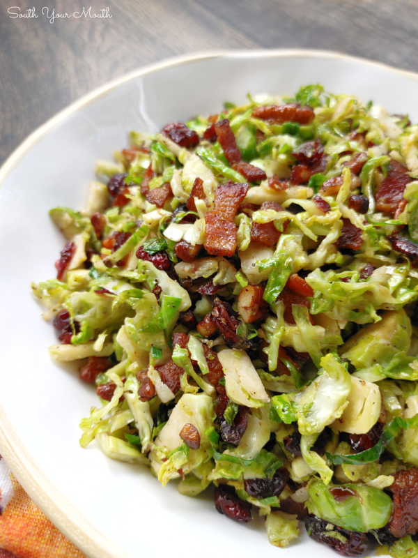 Craisin Bacon Shredded Brussels Sprouts! Thinly sliced brussels sprouts sautéed with crispy bacon, toasted crunchy pecans and sweet, tangy dried cranberries makes a perfect side dish recipe for Thanksgiving or Christmas dinner!