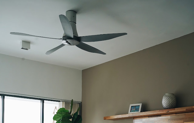 Angled fan blades on a ceiling fan.