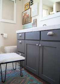 Bathroom Makeover - before & after - Zinc cabinet, gallery wall, World Market rug / mat and vintage hairpin leg stool 