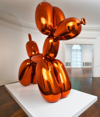 Source: Qatar Museum. Jeff Koons's balloon dog statue in a copper shade.