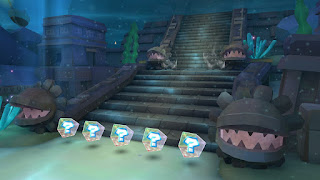 a staircase with rock statues of Petey Piranha on each side
