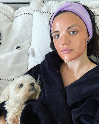 Lucy Hale self-care pampering facial sheet mask and maltipoo dog Elvis