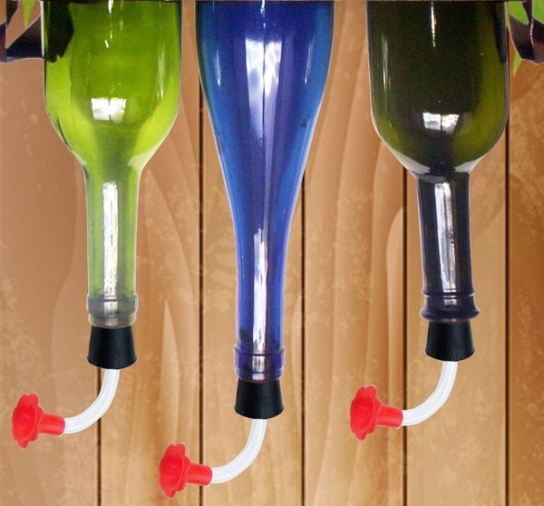 three DIY hummingbird feeders made from recycled bottles
