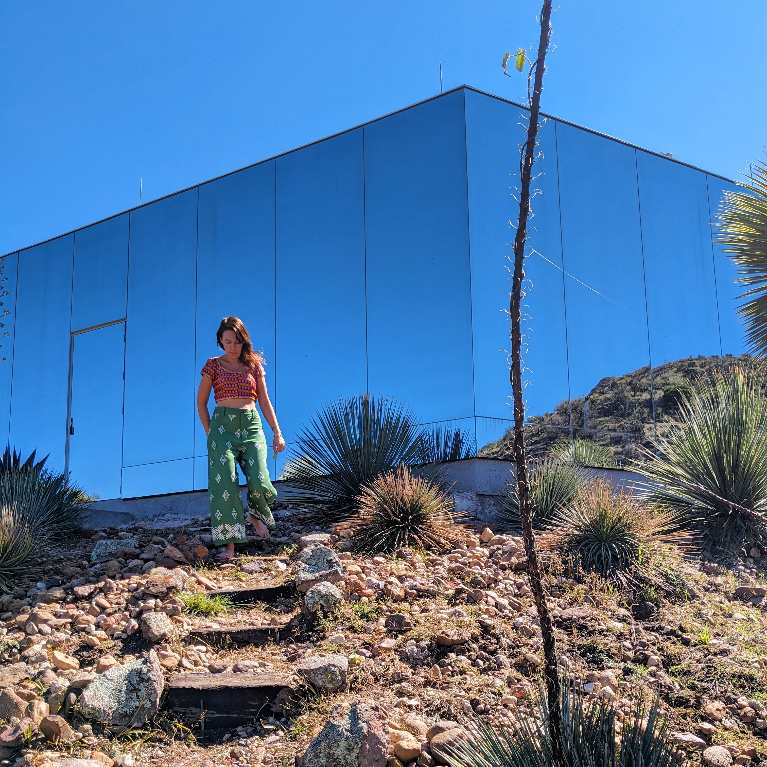 Lydia Swinscoe stands outside of Mexico's Casa Eterea, a mirrored house that sits in the foothills of an extinct volcano