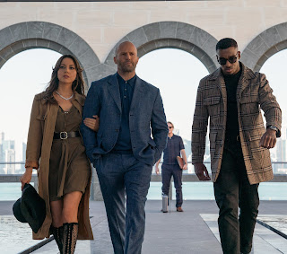 Aubrey Plaza as Sarah Fidel, Jason Statham as Orson Fortune, and Bugzy Malone as Bugzy in OPERATION FORTUNE.