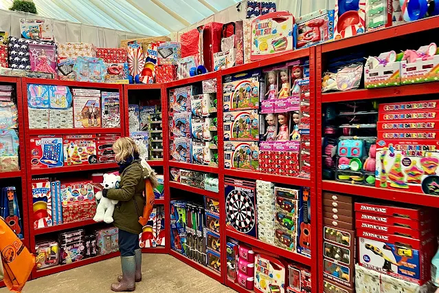 A child in the toy shop choosing a present from Father Christmas from a huge range of choices