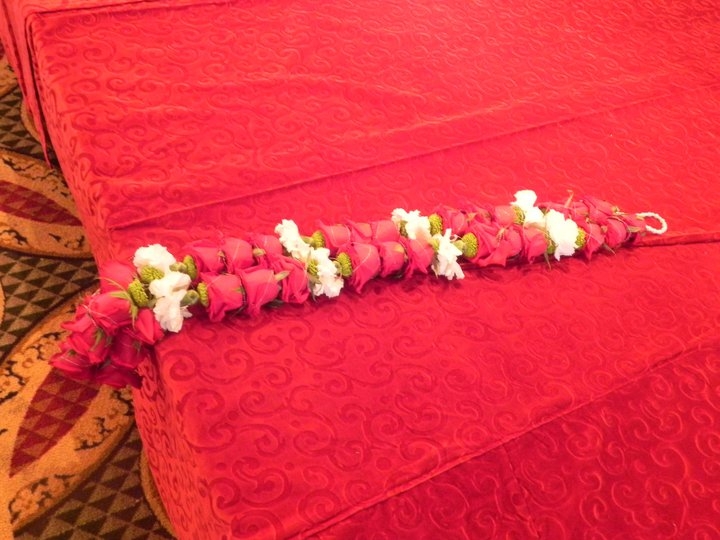 the ritual of exchanging the garlands with a stylish lei of blooms