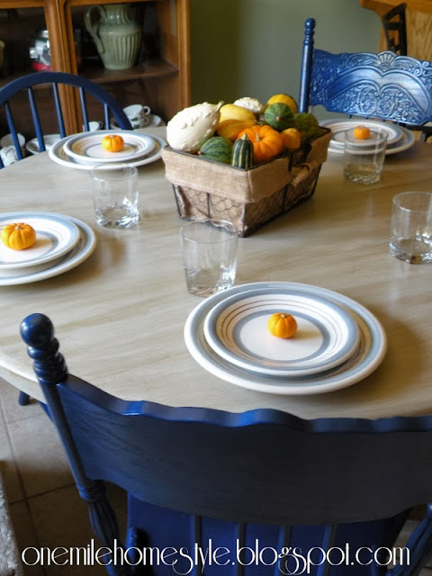 Fall table setting on cream table with nave blue chairs