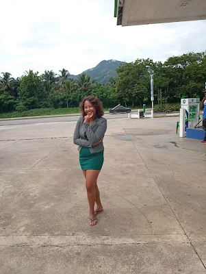 "Shachem Lieuw standing in front of a mountain at a service station in the Dominican Republic"