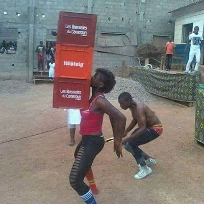 woman lifts crates of beer with her boobs in cameroon