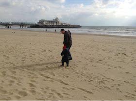 My boys walking along the beach at Bournemouth