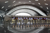 A passenger walks in a terminal upon his arrival at the new Hamad International Airport.