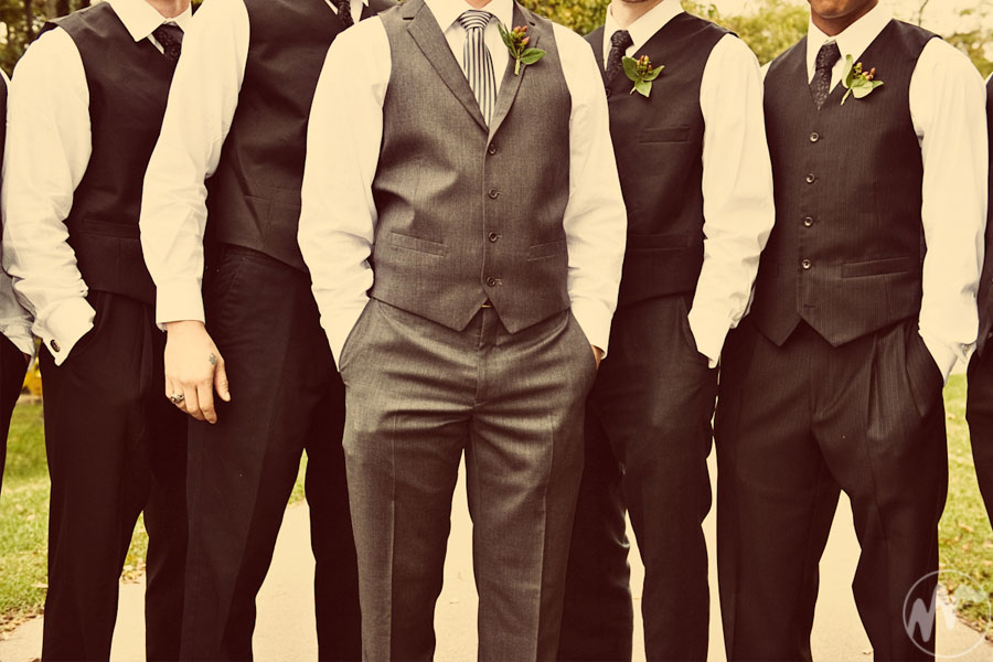 groom and his groomsmen traditionally wear the same suit at a wedding