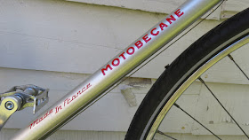 Silver bicycle frame with red lettering.