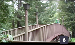 screen shot of Dan leaning over the railing of the footbridge