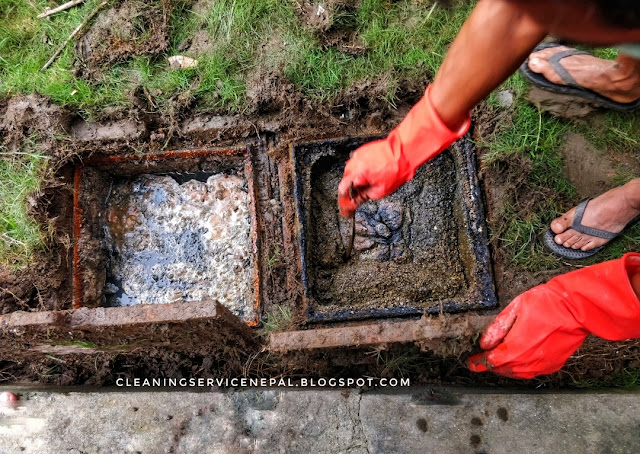 a man cleaning sewage inspection chamber