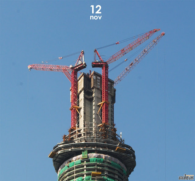 Photo of four red tower craned building the central core