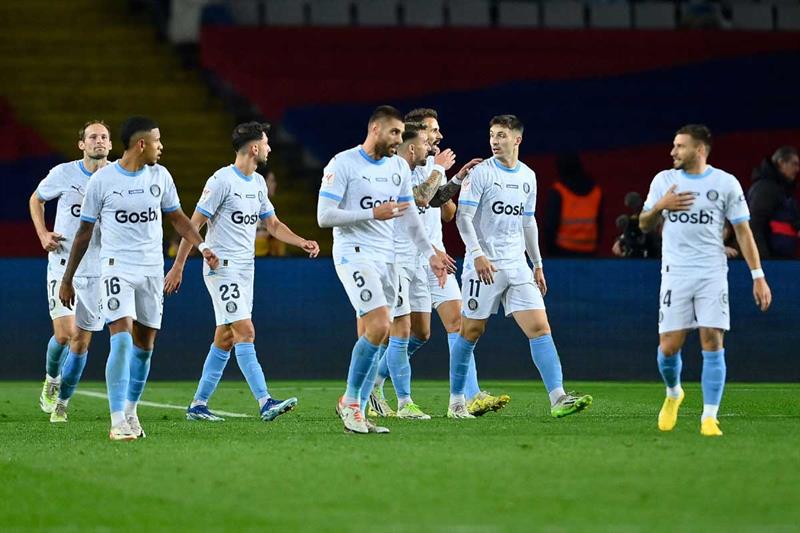 Girona s Spanish defender #11 Valery Fernandez celebrates with teammates after scoring his team s third goal