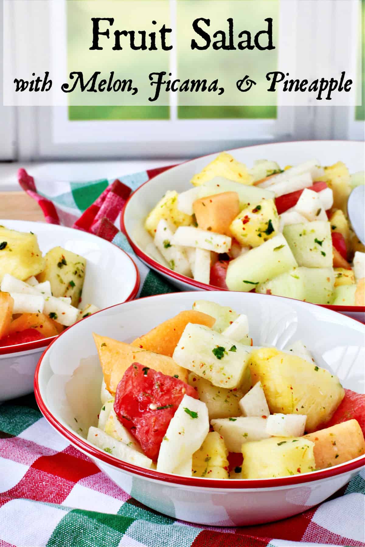 Melon, Jicama, and Pineapple Salad in bowls with red rims.