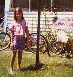 Me next to the sign for Gramma's ceramic shop.