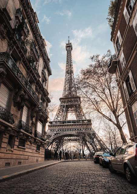 view of Eiffel Tower from along Parisian street