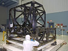 NASA engineers check out the unwrapped ISIM structure in a clean room