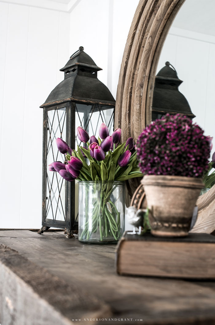 Purple flowers on wood mantel