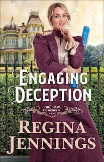 Book cover of Engaging Deception features a blonde haired woman in a burgandy 19th century gown holding rolled up blueprints