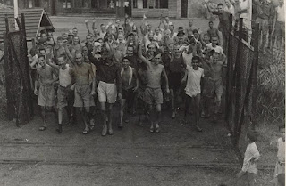 Allied prisoners piling out of the main gate of the Changi Prison, Singapore,  1945