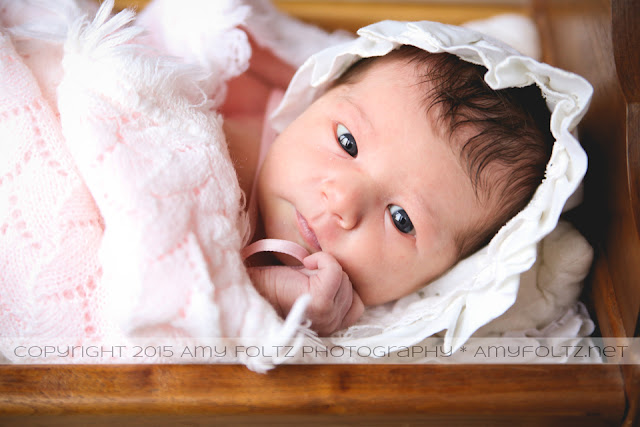 newborn in doll cradle