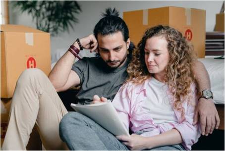 a couple writing a list of who to notify when moving house