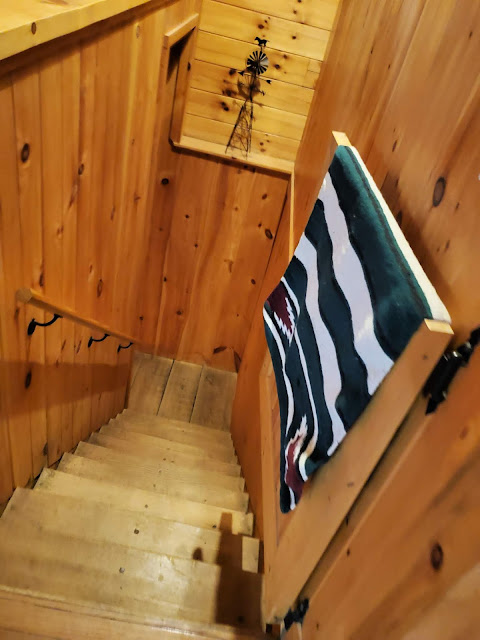Stairs to lower level in Getaway Cabins Whispering Woods #25 cabin in the Hocking Hills