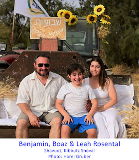 Father, son and mother dressed in white, sitting in front of a tractor decorated with flowers